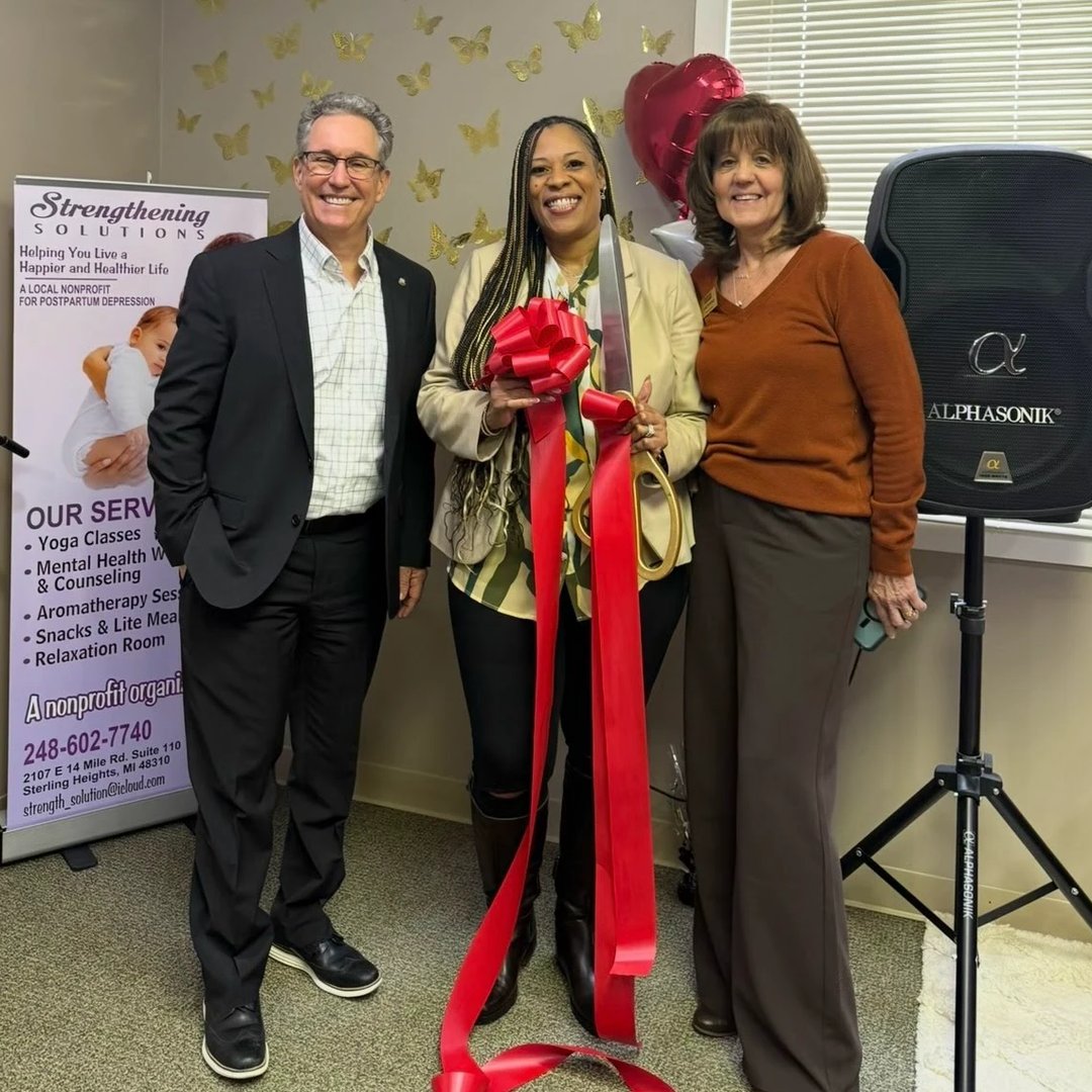 Strengthening Solutions founder Twanda Lane cutting the ribbon at the Strengthening Solutions office alongside Eastside Community Chamber President Linda.