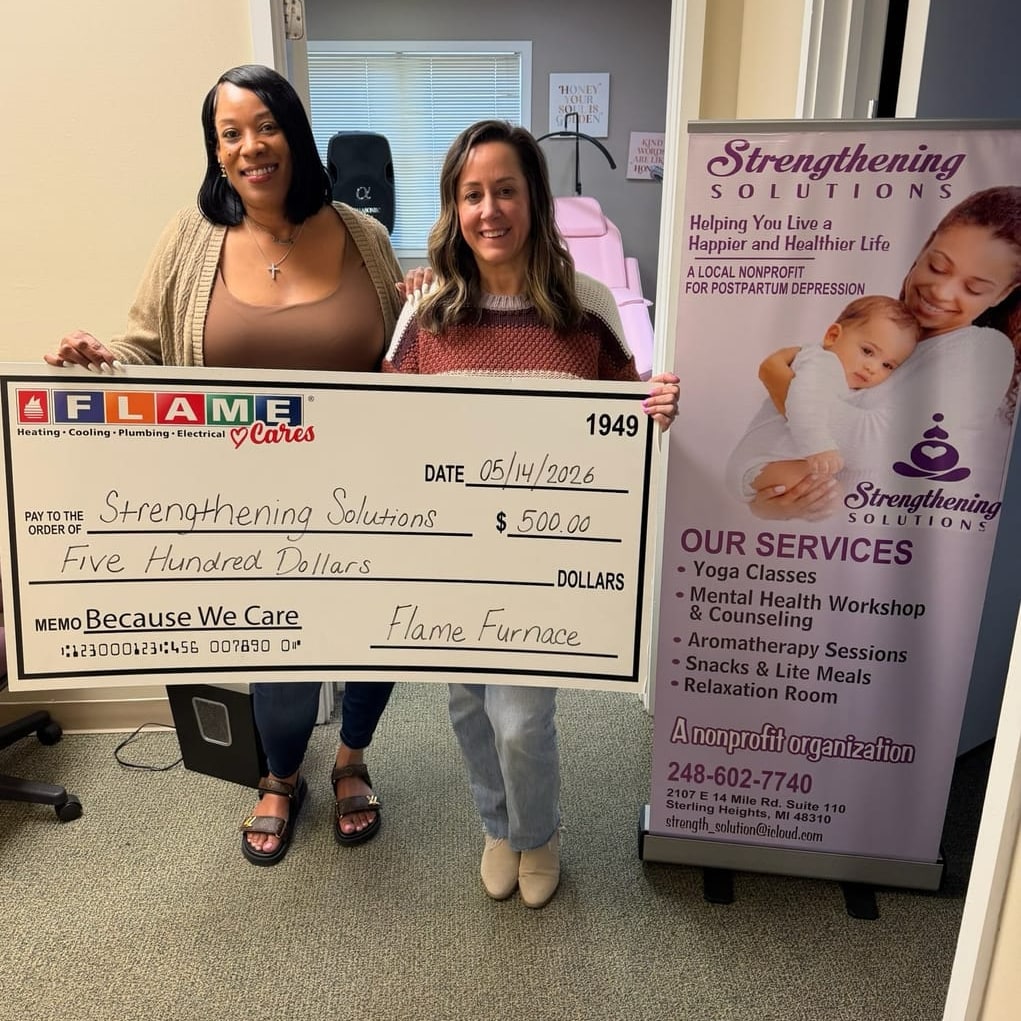 Flame Furnace presenting a $500 “Because We Care” donation check to Strengthening Solutions.